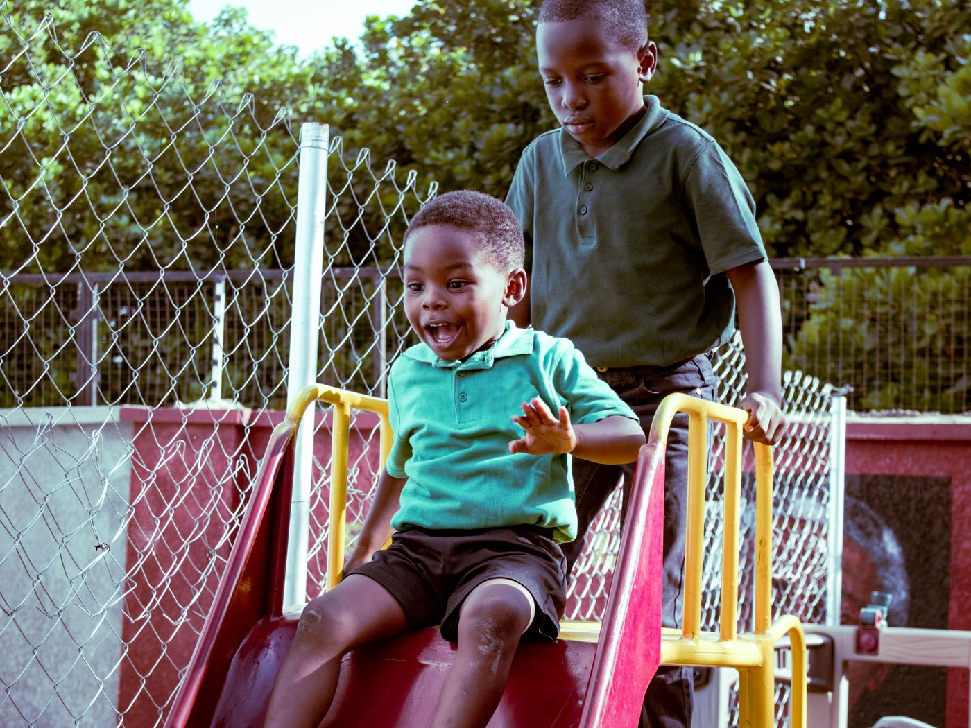 Illustrative children playing on outdoor playground equipment, not the actual school or pupils