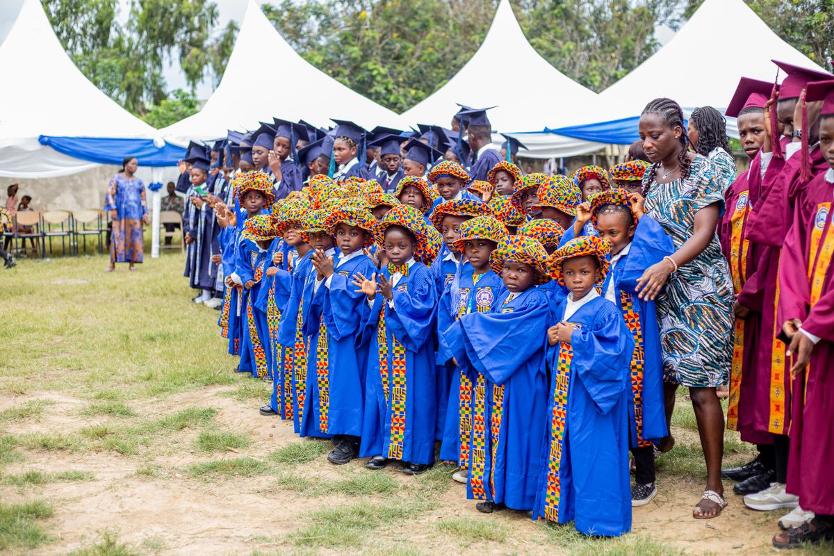 Illustrative early years pupils and teachers together at a school celebration, not the actual school or pupils