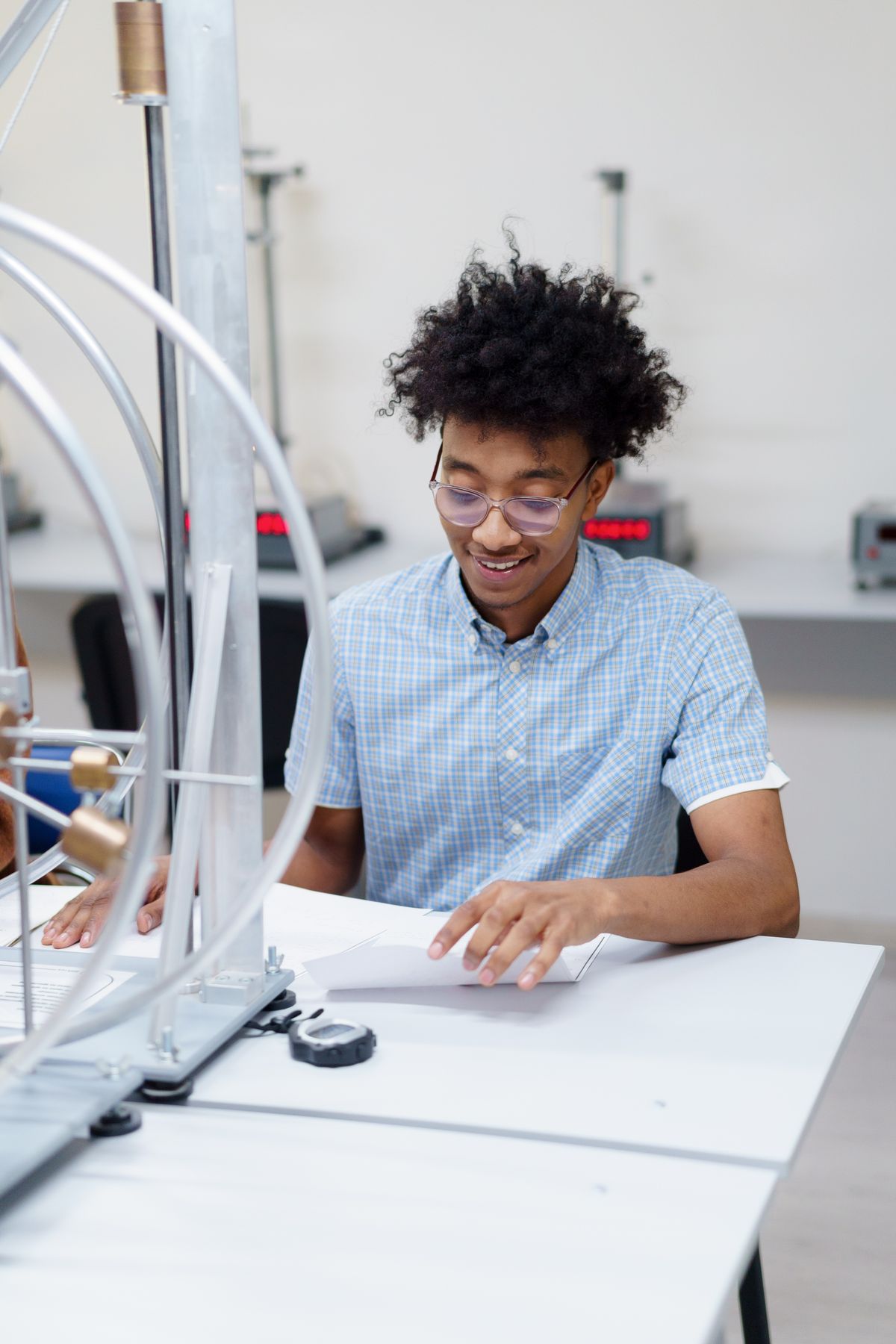 Illustrative secondary student working with physics laboratory apparatus, not the actual school or pupils